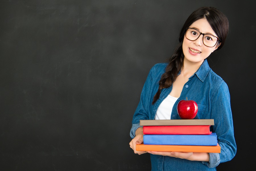 teacher in room with books