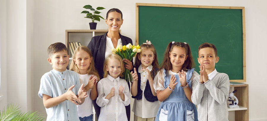 students giving flower to teacher